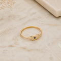 Aurora Sapphire Signet Ring on ivory marble